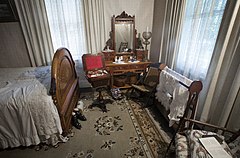 A 19th century bedroom with a vanity mirror and personal hygiene paraphernalia. Victorian Village, Museum of Transport and Technology (MOTAT) , Auckland, New Zealand.