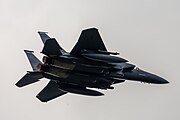 An F-15E Strike Eagle, tail number 91-0302, taking off from RAF Lakenheath in England. The aircraft is assigned to the 492nd Fighter Squadron.