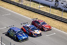 Giulia ETCR (right) lined up with its ETCR competitors, the Cupra e-Racer (left) and Veloster N ETCR (centre) 2022 ETCR - RD3 - Jarama (52186793050).jpg