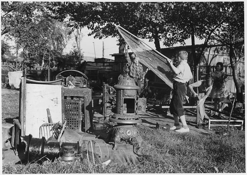 File:A couple of husky Junior Commnados add to a neighborhood scrap pile in Roanoke, Va. Bedsprings, coal buckets, bird... - NARA - 196334.jpg