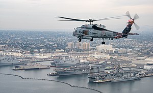 An MH-60R Sea Hawk helicopter flies over San Diego. (24546100368).jpg
