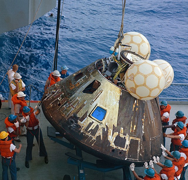 Crews on the Iwo Jima hoisting the Apollo 13 command module Odyssey on board.