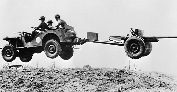 A 1941 Bantam achieving total lift-off, loaded with 3-man crew, and towing a 37mm anti-tank gun. "Flying Jeep" photos like this one inspired posters and perhaps the 'Leaping Lena' nickname.
