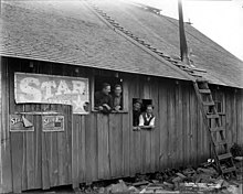 Crew looking out of camp building windows, Brookings Timber and Lumber Company, Brookings, ca. 1919 Crew looking out of camp building windows, Brookings Timber and Lumber Company, Brookings, ca 1919 (KINSEY 2158).jpeg