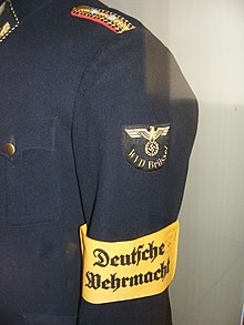Rank insignia for a railway official in paygrade 9a/9, serving in Wehrmachts-
Verkersdirektion Brussel (occupied Belgium). The yellow armlet denotes him as a combatant according to the law of war. DB Museum Nurnberg - Uniformteile einer Amtsperson der Wehrmacht Verkehrsdirektion Brussel.jpg