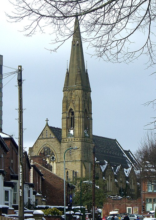 Photo of a former church with a prominent steeple.