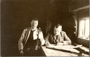 Gössa Anders Andersson, violonist and Nils Andersson writing down folk music (unknown date)