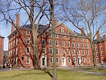 Hollis Hall: a four-story red brick building with white trim in a courtyard.