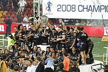 New Zealand lifting the Paul Barriere Trophy after their victory in the final. Kiwis Team Photo.jpg