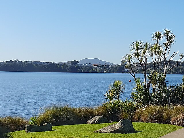 Lake Pupuke is a volcanic maar and the oldest known feature of the Auckland volcanic field, while Rangitoto Island (background) is the youngest