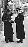 Custode with carbine conducting an investigation, 1942