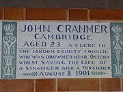 A tablet formed of six standard sized tiles, bordered by green flowers in the style of the Arts and Crafts movement