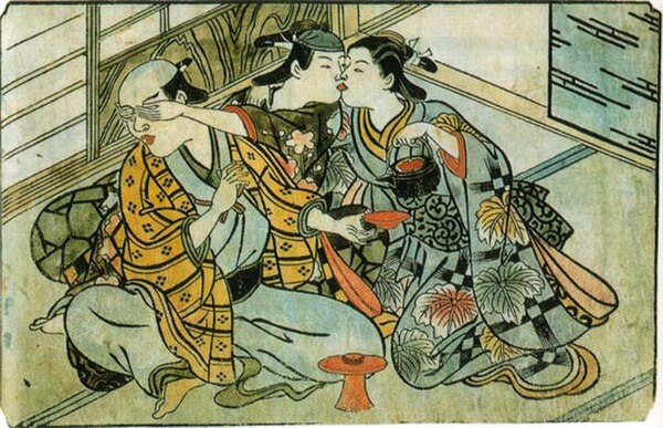 A wakashū (wearing headscarf) sneaks a kiss from a female prostitute behind his patron's back. Nishikawa Sukenobu, c. 1716–1735. Hand-colored print.