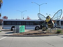A freestanding bee sculpture greets visitors to the upper level of the station. Norwalk Transit Bus and Bee.jpg