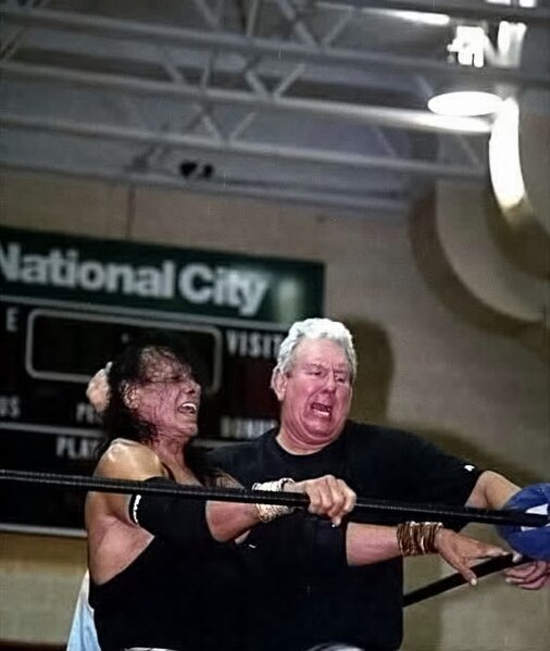 Orton (right) driving Jimmy Snuka into a turnbuckle in 2009