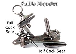 With the classic Spanish patilla style miquelet lock, the mainspring pushes up on the heel of the hammer and both sears engaged the toe of the foot. Patilla Style Miquelet Lock.jpg