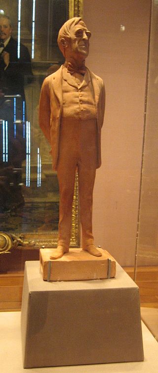 A terracotta statuette dated 1873 by caricaturist Carlo Pellegrini of Lowe standing on a box of matches inscribed 'Ex luce lucellum'