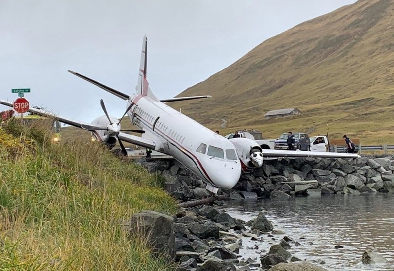 Small plane crashes into car after overshooting runway during