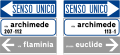 Esempio di gruppo segnaletico comprendente segnali di avvio a strade o piazze importanti, di nome strada e di senso unico (con vecchi caratteri)