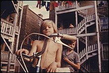 A neighborhood of poor white people, Chicago, 1974 TWO YOUTHS IN UPTOWN, CHICAGO, ILLINOIS, A NEIGHBORHOOD OF POOR WHITE SOUTHERNERS. THE INNER CITY TODAY IS AN... - NARA - 555950.jpg