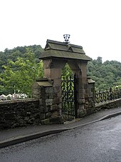 The east gate to the church; the churchyard wall, railings and gates, contemporary with the church, are Grade II listed. The church gate at Holy Trinity, Coalbrookdale - geograph.org.uk - 1462299.jpg