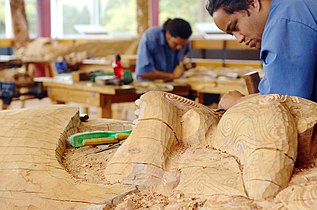 Maori students carving wood in New Zealand