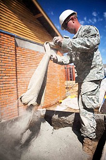 Cement powder, here conditioned
in bag, ready to be mixed with aggregates and water. Dispersing dry cement dust in the air should be avoided to prevent health issues. USMC-110806-M-IX060-148.jpg