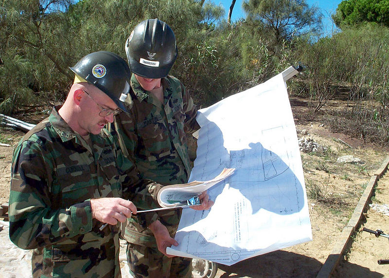 File:US Navy 021123-N-5152S-001 Builder 1st Class Floyd Cornell (left) reviews specifications with Builder 3rd Class Jason Martin.jpg