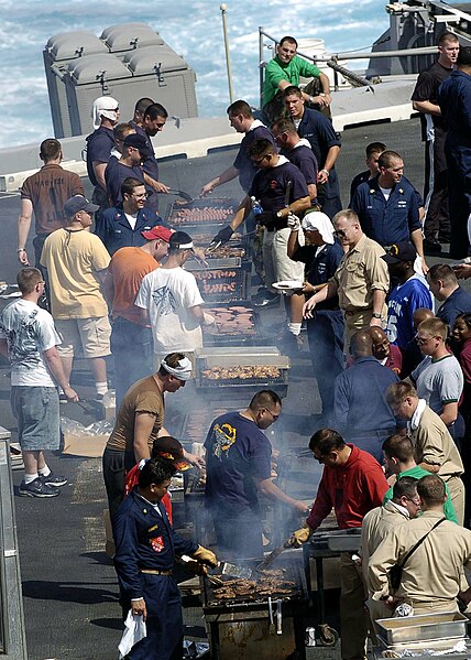 File:US Navy 041024-N-0057P-058 Crew members aboard the Nimitz-class aircraft carrier USS Abraham Lincoln (CVN 72) prepare steaks, chicken, hotdogs, and hamburgers over charcoal grills during a Steel Beach picnic held on the flight.jpg