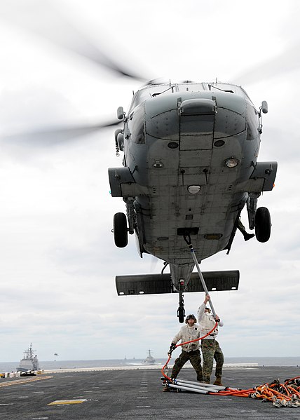 File:US Navy 090218-N-2636M-146 Marines assigned to the 22d Marine Expeditionary Unit (MEU) latch a net sling to an MH-60S Sea Hawk helicopter during a vertical replenishment aboard the amphibious assault ship USS Bataan (LHD 5).jpg