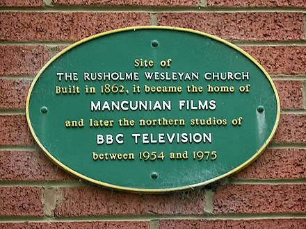 A plaque on a house wall marks the former site of Dickenson Road Studios