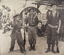 Soldiers in a 40 Commando base pose with the severed head of an MNLA guerrilla, 1951. 28th April This is the War in Malaya.jpg