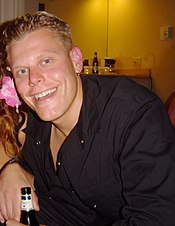 A man in his late 20's with light hair, smiling at the camera.