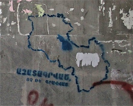 Graffiti in Yerevan with the outline of a united Armenia and Republic of Artsakh, with text in Armenian saying "Liberated, not occupied"