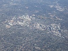 Aerial view of Downtown Bethesda at bottom right, with the National Institutes of Health campus at upper left and Walter Reed National Military Medical Center campus to the right Bethesda aerial 2019.jpg