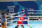 Deutsch: Boxen bei den Olympischen Jugendspielen 2018 Tag 12, 18. Oktober 2018 - Finale Fliegengewicht Mädchen – Martina La Piana (Italien, blau) schlägt Adijat Gbadamosi (Nigeria, rot) 5-0; Ringrichter ist James Beckles (Trinidad und Tobago). English: Boxing at the 2018 Summer Youth Olympics on 18 October 2018 – Girl's flyweight Gold Medal Bout - Martina La Piana (Italy, blue) beats Adijat Gbadamosi (Nigeria, red) 5-0; Referee is James Beckles (Trinidad and Tobago). Español: Boxeo en los Juegos Olímpicos Juveniles de Verano de 2018 en 18 de octubre de 2018 - Combate a medalla de oro de peso mosca para mujeres: Martina La Piana (Italia, azul) le gana a Adijat Gbadamosi (Nigeria, roja) 5-0; El árbitro es James Beckles (Trinidad y Tobago).