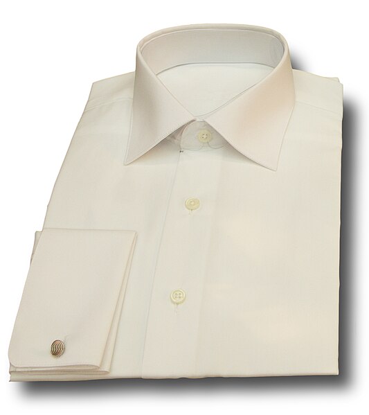A folded white dress shirt with French double cuffs.