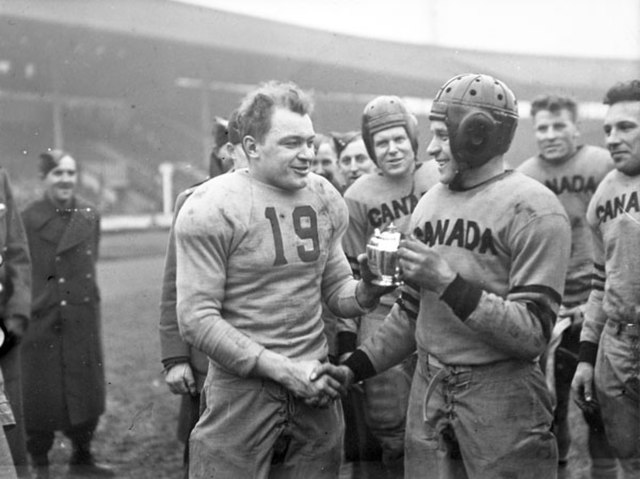 Team captains shake hands after a Canada-United States American football game at White City Stadium, 14 February 1944