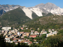 View of Carrara; the white on the mountains behind is quarried faces of marble. Carrara.PNG