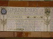 A tablet formed of five tiles of varying sizes, bordered by yellow and blue flowers in an art nouveau style