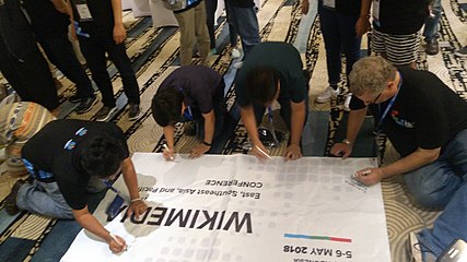 closing activity:participants writing on the conference tarpaulin