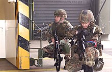 An airman of the German Air Force Regiment (right) together with an American Security Forces Specialist during a counterterrorism exercise at Buchel Air Base, Germany in 2007 ExerciseBuechelAB.jpg