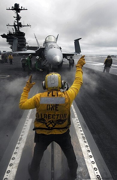 File:FA-18C Hornet being directed for takeoff on the USS John C Stennis.jpg