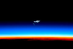 Image 7Afterglow of the troposphere (orange), the stratosphere (whitish), the mesosphere (blue) with remains of a spacecraft reentry trail, and above the thermosphere without a visible glow (from Earth)