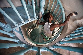 A man painting a staircase in India