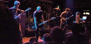 Isis in 2009. From left to right: Michael Gallagher, Jeff Caxide, Aaron Turner and Bryant Clifford Meyer (with Aaron Harris in the background).