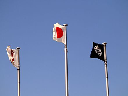 The national flag flying with the flags of Okinawa Prefecture and Urasoe City