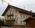 Kirchstraße 5; Hakenhof, sogenannt Beim Schwarzhuber, zweigeschossiger Satteldachbau mit Kniestock, Wohnteil mit Putzgliederungen, Eisenbalkonen und Giebelzier, 1878 This is a picture of the Bavarian Baudenkmal (cultural heritage monument) with the ID D-1-84-141-5 (Wikidata)