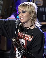 "Flowers" by Miley Cyrus (pictured) is the longest-running number-one single of 2023, spending fifteen consecutive weeks atop the Canadian Hot 100. It later ranked as the best-performing single of the year. LXivr5hdBjE.jpg