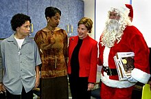 Iran Brown, survivor of the snipers' shooting at Benjamin Tasker Middle School, with First Lady Laura Bush in December 2002. Laura Bush visits with D.C. sniper survivor Iran Brown in D.C. (12 December 2002).jpg